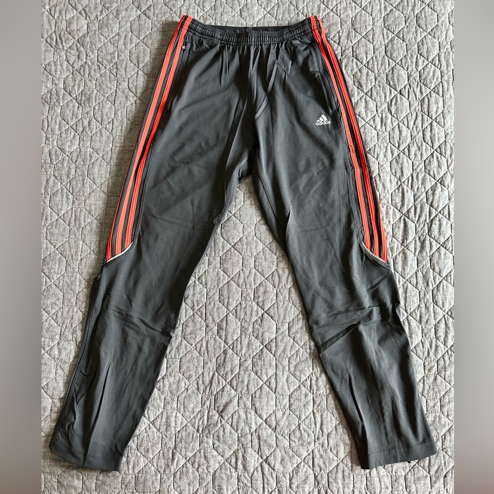 Adidas women’s black stretchy track pants with orange stripes and pockets - S/M